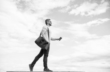 Man traveling on vacation with travel bag and document sky background, copy space.