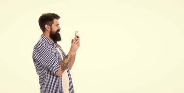 pozitif vahşi sakallı adam telefonuyla fotoğraf çekiyor beyaz arka planda kopyalama alanı ile izole edilmiş..