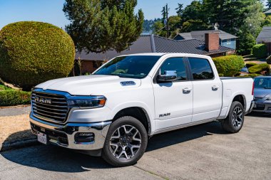 Seattle, WA, USA -July 3, 2024: 2025 RAM 1500 LARAMIE CREW CAB 4X4 57 BOX white, side corner view. clipart