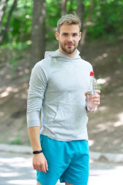 Vücutta su dengesi. Günde bir içki. Sıvı yeterliliği durumu. Susuz kalma. Susamış sporcu. Adam maden suyu tutuyor. Susadım. Plastik şişeli genç bir adam. Sağlıklı yaşam tarzı.