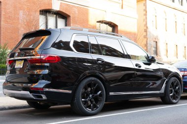 New York City, USA - March 15, 2024: BMW X7 luxury vehicle car parked outdoor, back side view. clipart