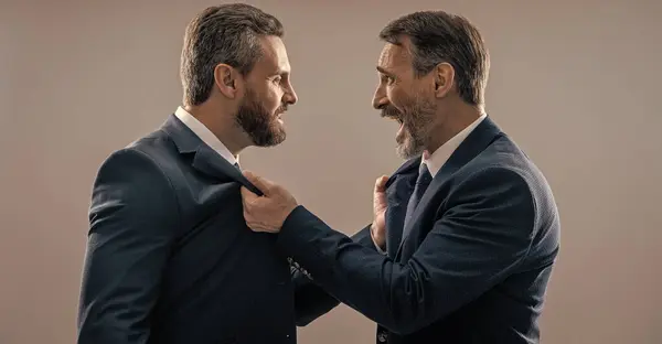 Stock image rival business company. businessmen having rivalry. rivalry in the business world. historic rivalry. rival strategy of businessmen isolated on grey. business competition and rivalry.