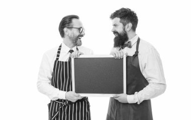 partners celebrate start up. catering business. welcome on board. bearded men with blackboard, copy space. menu planning. happy chef team in apron. cafe and restaurant opening. start up business. clipart