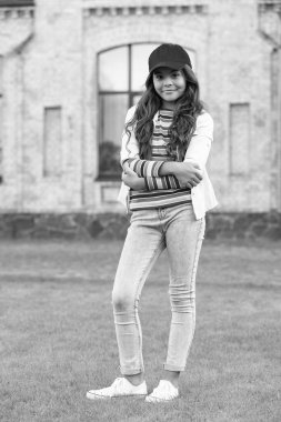 cheerful teen girl model keeping arms crossed. teen fashion style. teen kid standing outdoors.