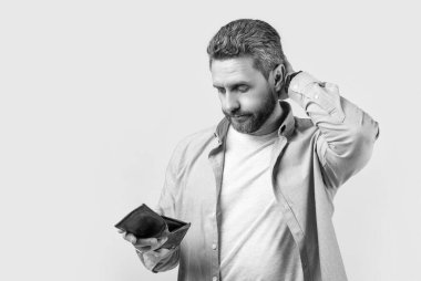 photo of puzzled bankrupt man with wallet. bankrupt man with wallet isolated on studio background. bankrupt man with wallet in studio. bankrupt man with wallet at hand.