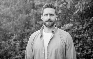 Portrait of handsome professional man in blue shirt natural background.