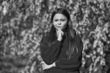thinking teen girl outdoor in autumn season.