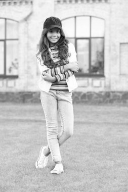Happy teen girl model keeping arms crossed. teen fashion style. teen child standing outdoors.