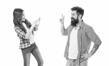 Mobile photography. Daughter taking photo of father. Future photographer. Settings of camera. Application for editing photo. Happy little girl hold smartphone or mobile phone white background.