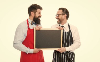 partners celebrate start up. catering business. welcome on board. bearded men with blackboard, copy space. menu planning. happy chef team in apron. cafe and restaurant opening. start up business. clipart