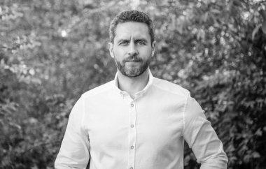 Handsome professional man in white shirt natural background.