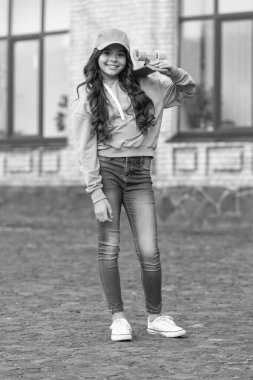 childhood of positive teen girl skater at the street. childhood of teen girl skater with skateboard. childhood of teen girl skater outdoor. childhood of teen girl skater outside.