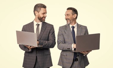 happy businessmen freelance in studio. photo of businessmen freelance with laptop. two businessmen freelance using laptop. businessmen freelance isolated on white background.