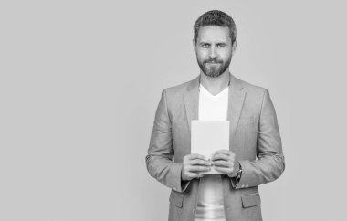 businessman with planner isolated on yellow background with copy space. businessman with planner in jacket. studio shot of businessman holding planner. photo of businessman hold planner.
