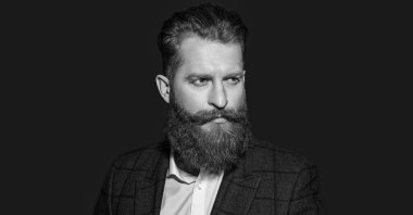 Arka planda takım elbiseli bir adamın yüzü. Resmi kıyafet giymiş sakallı bir adamın fotoğrafı. Kırmızı giysili adam izole edildi. Stüdyoda takım elbiseli bir adam..