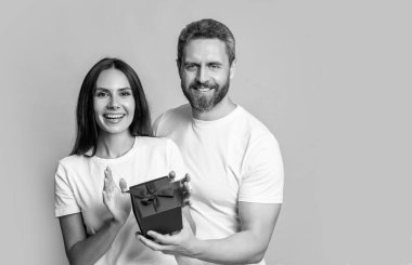 Sürpriz hediyeli çift, Banner. Sürpriz hediye kutusu olan tatil çifti. Tatil hediyesi olan bir çiftin fotoğrafı. Kadınlar Günü 'nde. Sarı arka planda şu anda izole edilmiş sürpriz çift.