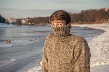 man in very cold winter outdoors. stylish man cold in winter outdoor. man feel cold in winter at holidays. man in cold winter wear sweater. clipart