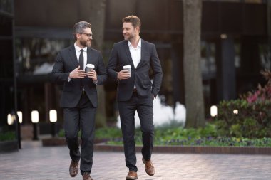 İş adamları işe gider. İş konuşuyoruz. Zarif takım elbiseli iki işadamı. Yürüyen meslektaşım. Meslektaşım ve arkadaşlarım. Dışarıda yürüyen iki başarılı iş adamı. Pankart.