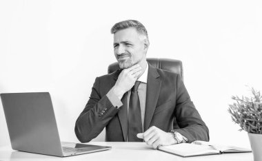 mature businessman sitting in business office have sore throat.