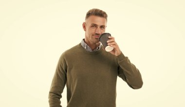 adult man drinking coffee on background. photo of man drinking coffee. man drinking coffee isolated on white. man drinking coffee in studio.