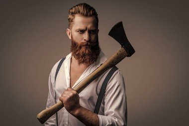 Retro tarzı. Yakışıklı ve karizmatik. Erkeksi adam. Baltası gri renkte olan sakallı bir adamın erkekliği. Sakallı ve bıyıklı, beyaz, vahşi bir adam. Erkeksi enerji. Hippi berber dükkanı..