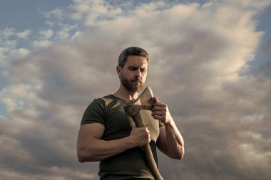 man with axe. woodcutter man hold ax. brutal man on dramatic sky background. clipart