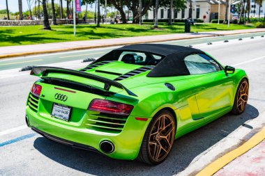 Miami Beach, Florida USA - 5 Haziran 2024: 2014 Audi R8 yeşil lüks araba Miami plaj caddesinde. Audi R8 okyanus yolunda.