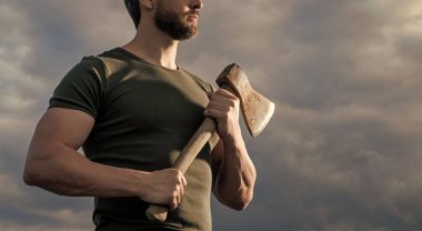 cropped view of strong man with axe. caucasian man hold ax. brutal man on sky background. clipart