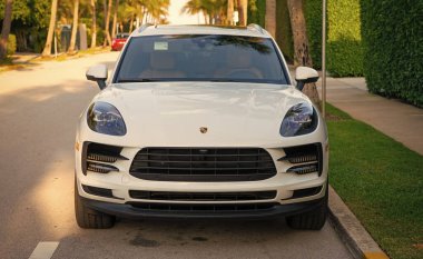 Palm Beach, Florida USA - March 22, 2021: white porsche car on road in palm beach. front view.