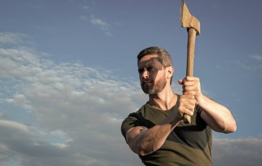 man threaten with axe. caucasian man hold ax. brutal man on sky background. copy space. clipart