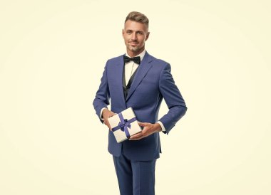 cheerful man hold gift box for mens or womens day.