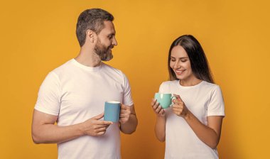 İki adam ve bir kadın çay içiyor. Aile günü. Sıcak bir ilişki. Evde kahve molası. Sarı üzerine izole edilmiş kahve içen aile çifti. Sabah kahvesi vakti. Derin sohbet.