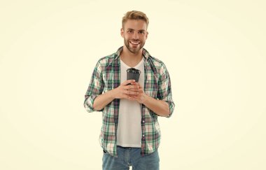 Kahvesi arka planda olan neşeli beyaz bir adam. Stüdyoda kahve içen beyaz bir adam. Kafkasyalı bir adamın kahveli fotoğrafı. Beyaz kahve içen beyaz tenli bir adam..