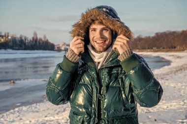 smiling man in winterwear outdoors. stylish man in winterwear outdoor. man in winterwear at holidays. man in winterwear jacket. clipart