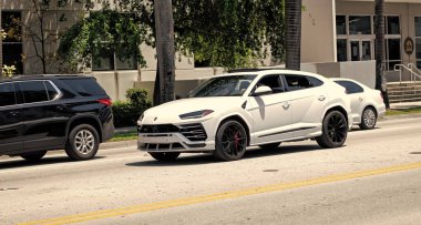 Miami Beach, Florida USA - April 15, 2021: 2019 white Giallo Auge Lamborghini Urus, corner view.