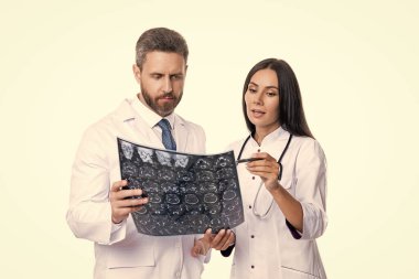 Modern bir hastanenin MRI veya tomografi odasında doktor onkolojisi. Doktor MR resmini inceler. Nörolog beyin teşhisi koydu. İki tıp uzmanı MRI taramalarını tartışıyor. Stüdyodaki doktor nörolog MRI. xray raporu.