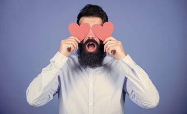 Making man feel loved. Happy in love. Man bearded hipster with heart valentine card. Celebrate love. Guy attractive beard and mustache in romantic mood. Feeling love. Dating and relations concept.