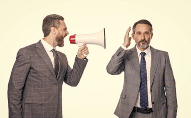 two businessmen ignore shouting loud in megaphone. businessmen ignore shouting in megaphone isolated on white. businessmen ignore shouting in megaphone at studio. businessmen ignore shouting
