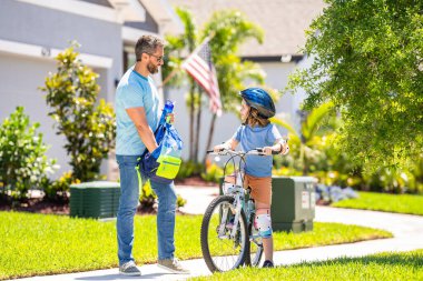 Father and son team in childhood. dad and son with childhood togetherness. Father and son sharing a biking childhood. outdoor family activities. father teaching son to ride a bicycle in his childhood. clipart