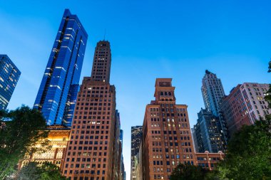 Business city. Night cityscape of Chicago skyscraper building. Chicago architecture of skyscraper. City night illuminated building. Skyscraper cityscape. Night city of Chicago. Low angle. clipart