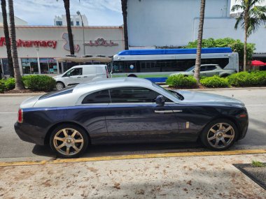 Miami Beach, Florida USA - June 8, 2024: 2014 Rolls-Royce Wraith luxury car at ocean drive miami beach. Rolls Royce is a British luxury car brand. side view clipart