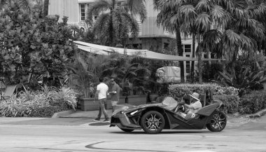 Miami Beach, Florida USA - March 19, 2021: blue polaris slingshot in miami, side view. three-wheeled motorcycle. clipart