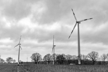 Rüzgar türbinleri. Yel değirmeni manzarası Elektrik için rüzgar türbini jeneratörü. Yeşil enerji kaynakları. Yel değirmeni türbinleri yeşil enerji üretiyor. Güç üretimi için yel değirmenleri. Offshore Yel değirmeni Çiftliği.
