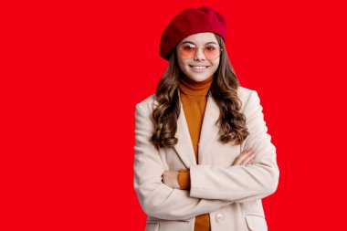 Autumn fashion girl. Trendy and stylish teenager girl, copy space. Fall fashion style for teen. Complete outfit for fall style. Girl in autumn coat isolated on red. Teen girl wear sunglasses. clipart