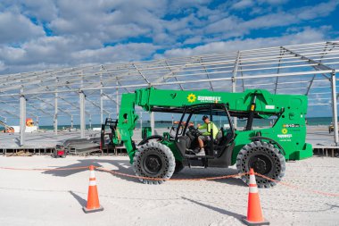 Miami, Florida, USA - November 16, 2024: Telescopic Boom Lift. Sunbelt Rentals boom lift outdoor. Machine equipment. Heavy equipment boom lifting machinery. Sunbelt Rentals Genia Z62-40 at beach. clipart