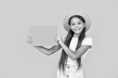 cheerful teen girl with copy space on orange paper on yellow background.