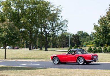 Chicago, Illinois, USA - September 08, 2024: Triumph tr4 retro convertible car, side view. Retro car. red Retro triumph tr4 . Triumph tr4 at Chicago clipart