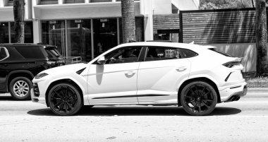 Miami Beach, Florida USA - April 15, 2021: 2019 white Giallo Auge Lamborghini Urus, side view.