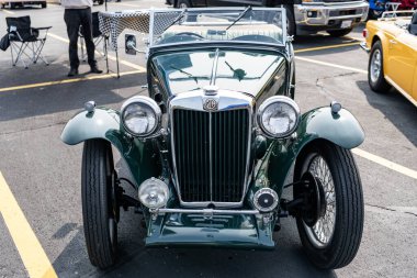 Chicago, Illinois, USA - September 08, 2024: MG TC roadster two seater retro sportscar convertible vehicle, front view. Retro sportscar green color. Convertible MG TC car. MG TC at Chicago clipart