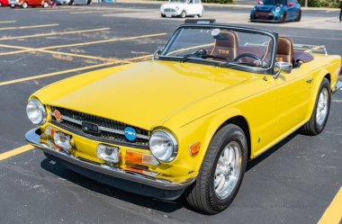 Chicago, Illinois, ABD - 08 Eylül 2024: Triumph tr 6 üstü açılır araba, köşe manzara. Retro araba. Sarı Retro zaferi 6 numara. Chicago 'da Zafer Tr6